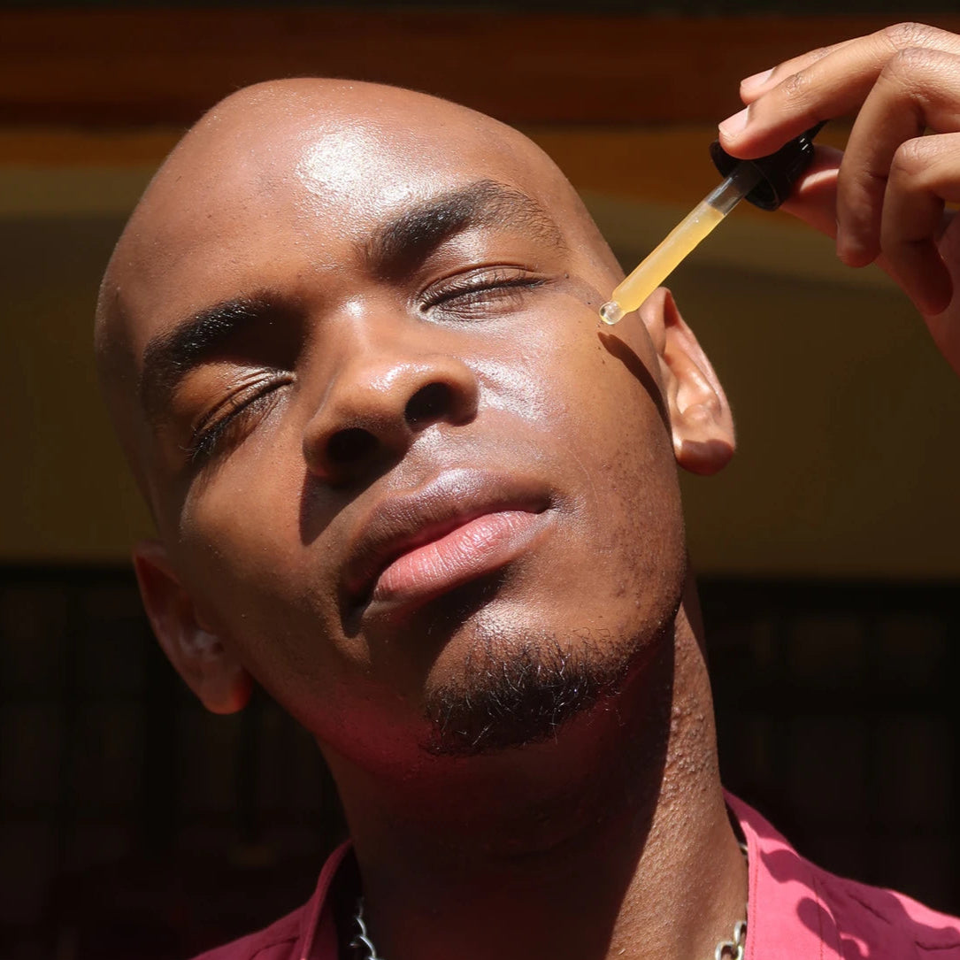 Skincare routine with Bakuchiol and Spirulina serum – man moisturizing face