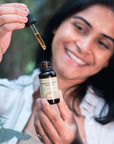 Woman presenting Face Oil with Baobab
