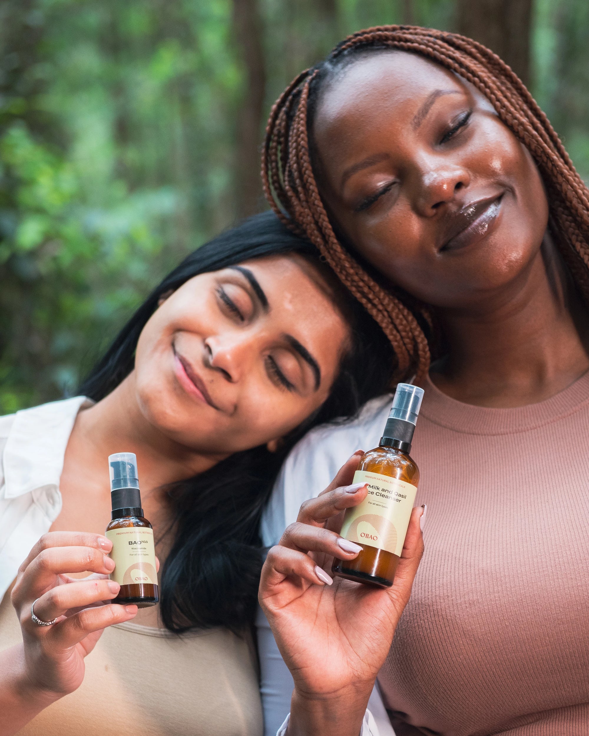 Two women holding Baobab products.