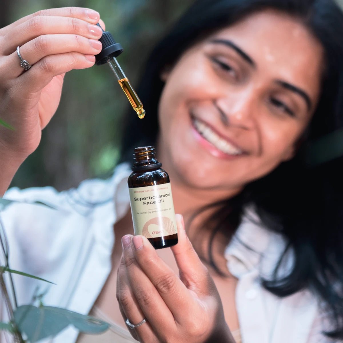 Woman presenting Face Oil with Baobab